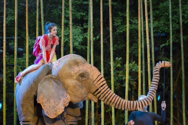 Ava Potter as Lilly riding Oona the elephant in Michael Morpurgo's Running Wild Live